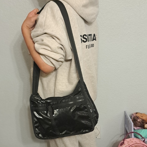 Lesportsac Handbags - LeSportsac Deluxe Everyday Bag in a black shine or patent finish.
